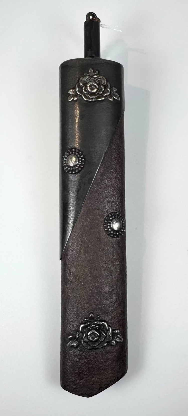 Japanese kayaku-ire gunpowder flask circa 1868–1912 with textured reddish-brown body and silver-coloured floral fittings