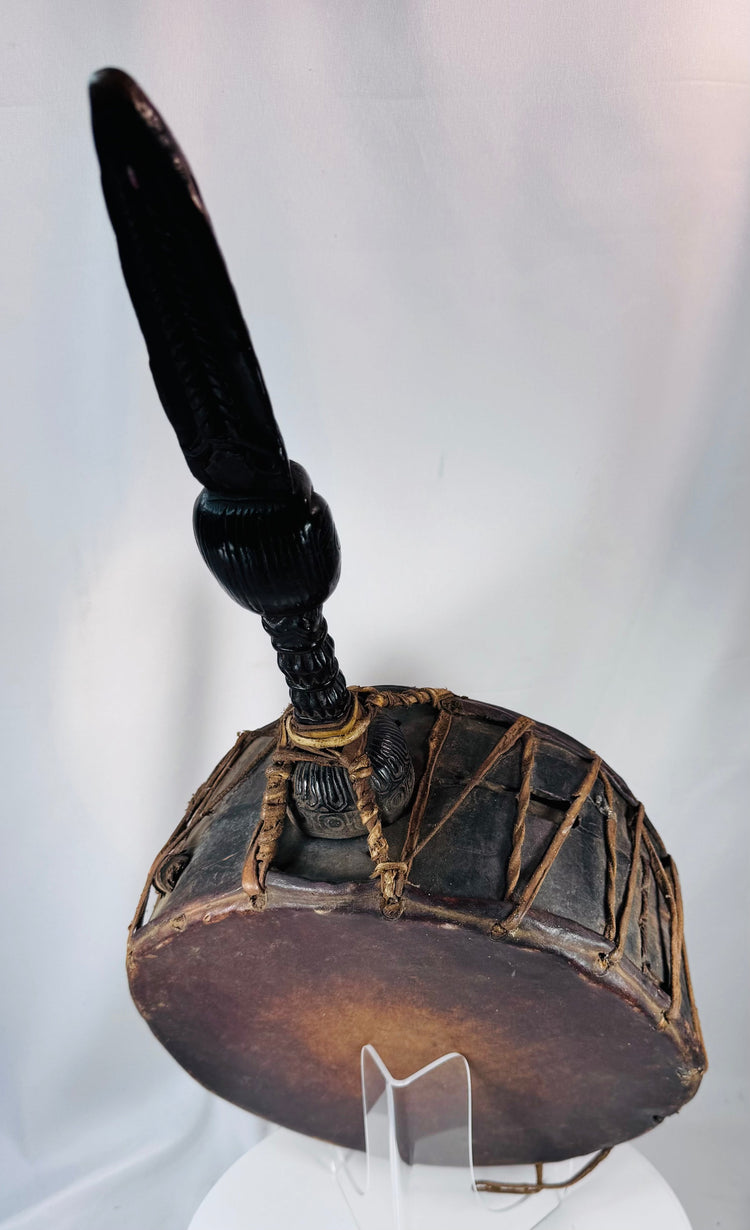 Handcrafted Nepal shaman's drum with original striker, carved handle, and evidence of prolonged ceremonial use.