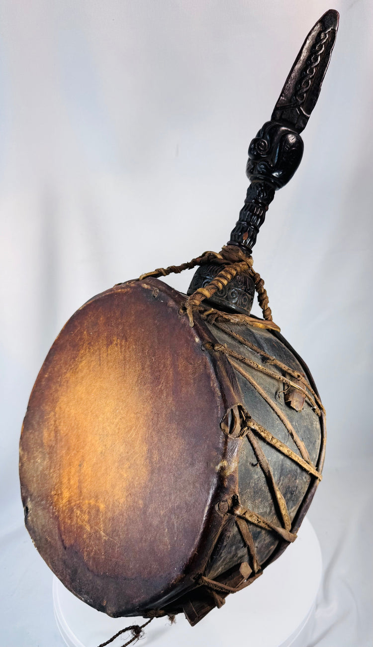 Historic Nepal shamanic drum with richly patinated wooden body and hand-carved spiritual imagery.