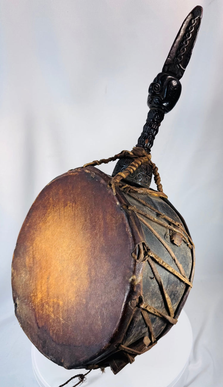 Historic Nepal shamanic drum with richly patinated wooden body and hand-carved spiritual imagery.