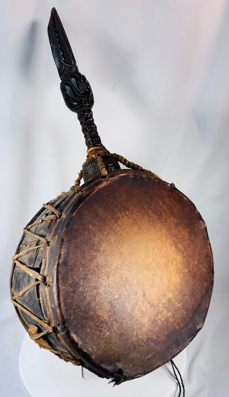 Antique Nepalese ceremonial drum with carved symbolic handle, hide surfaces, and original striker.