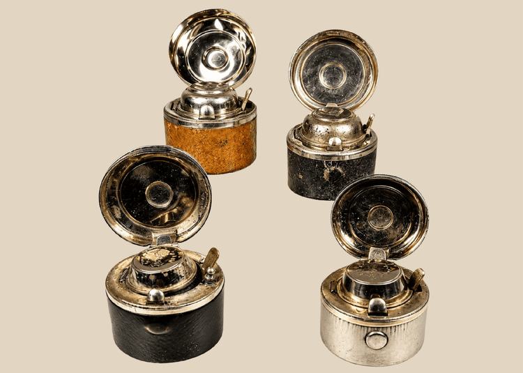Antique portable inkwells set with leather-wrapped bodies and glass inserts