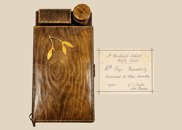 Antique leather writing slope with gilt detailing and inkwell compartment