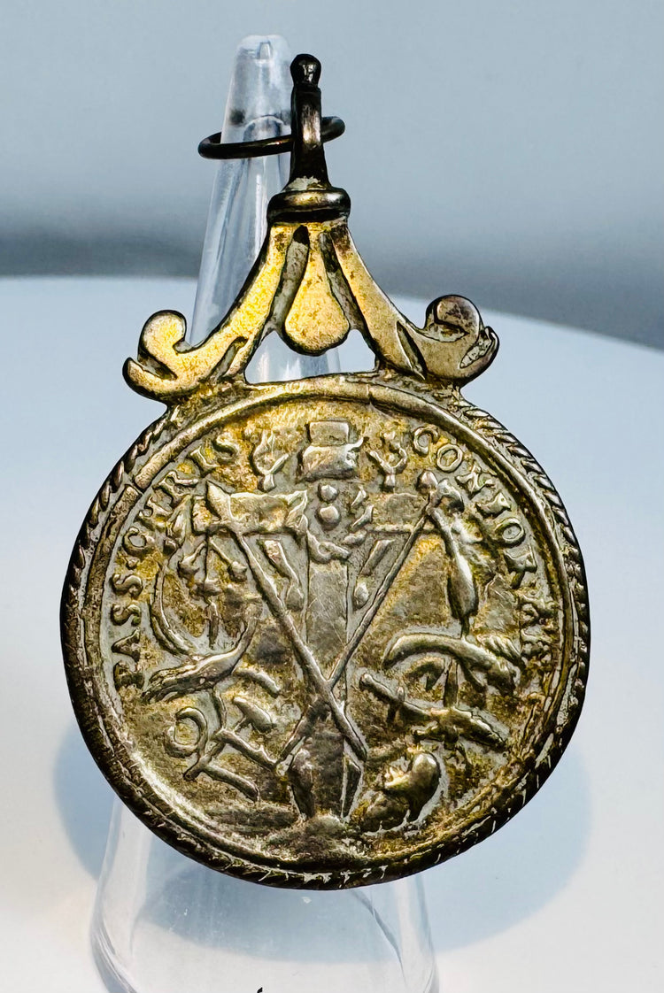 Antique cast silver pendant medal with ornate suspension loop and Christian iconography.