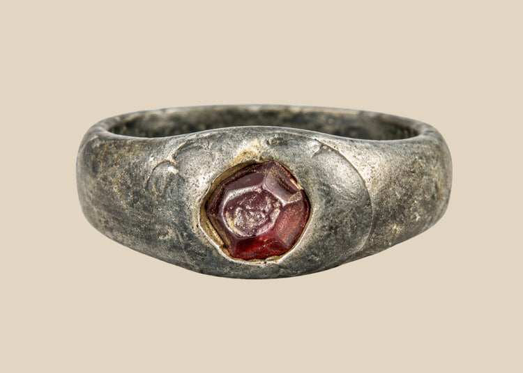 Ancient Sassanian silver ring with polished carnelian intaglio gemstone featuring engraved design, circa 224–651 CE, used as both personal adornment and functional seal.