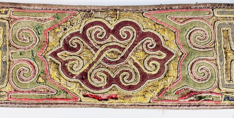 Close-up of Tibetan embroidered belt with colourful scroll and key-pattern decoration