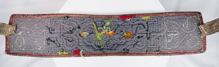 Back view of Tibetan warrior belt showing hand stitching, straps, wear, and old repairs