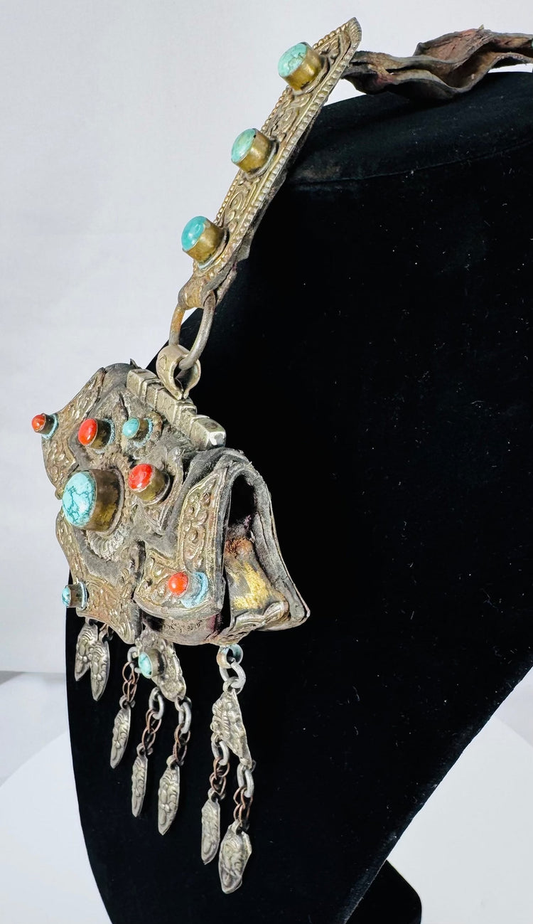 Museum-quality Tibetan gau pendant from the Himalayan region with decorative repoussé details and sacred amulet compartment.
