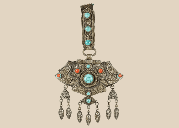 Antique Tibetan gau portable shrine pendant crafted from silvered copper alloy with turquoise and coral cabochons.