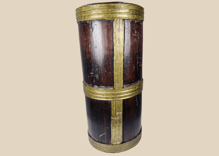 Antique Tibetan hardwood storage vessel with brass bands and traditional Himalayan coopered construction.