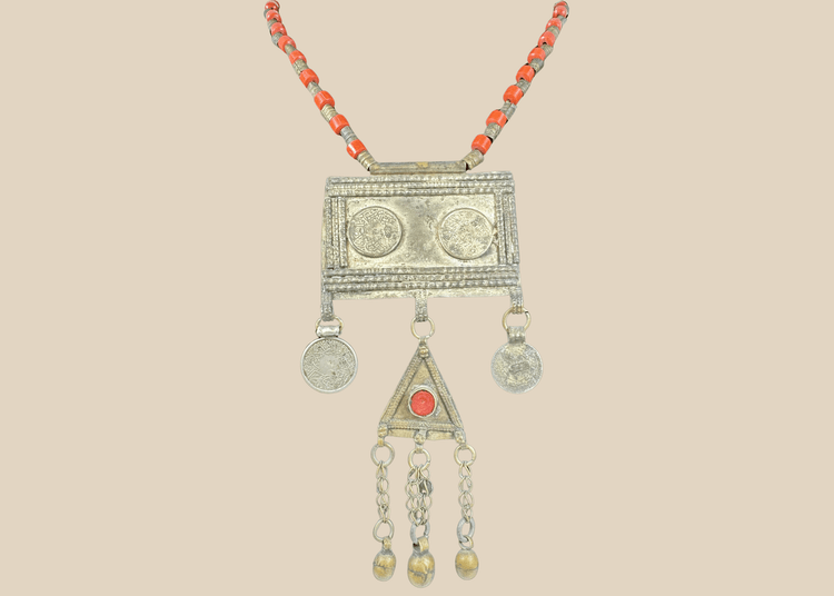 Antique Turkmen tribal necklace with a rectangular pectoral pendant, tumar amulet, and red glass beads.