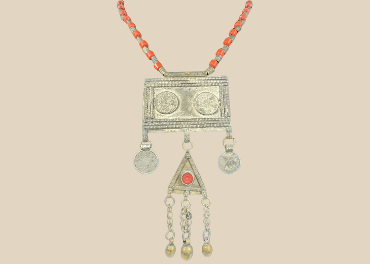 Antique Turkmen tribal necklace with a rectangular pectoral pendant, tumar amulet, and red glass beads.