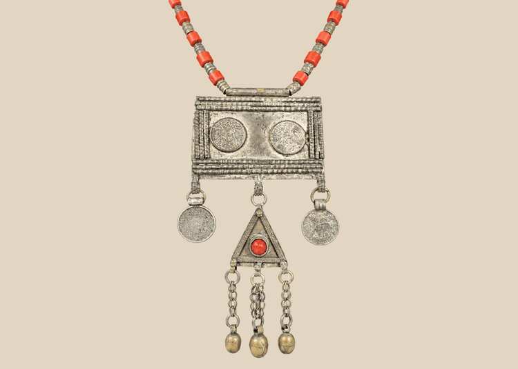 Antique Turkmen tribal necklace with a rectangular pectoral pendant, tumar amulet, and red glass beads.