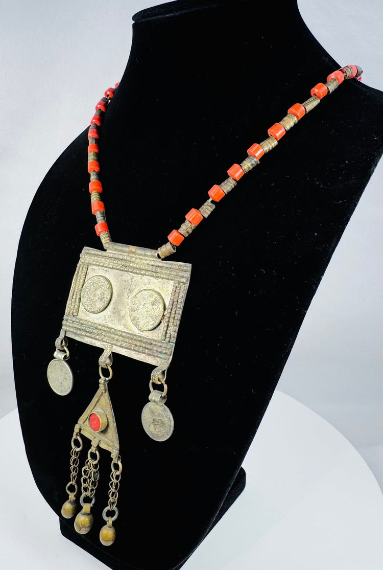 Traditional Turkmen necklace showcasing a large pectoral ornament, geometric decoration, and protective tumar amulet.
