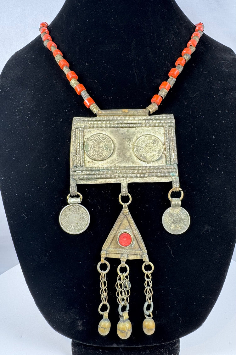 Central Asian Turkmen ceremonial necklace featuring silver-toned metal, coin pendants, and a triangular tumar pendant.