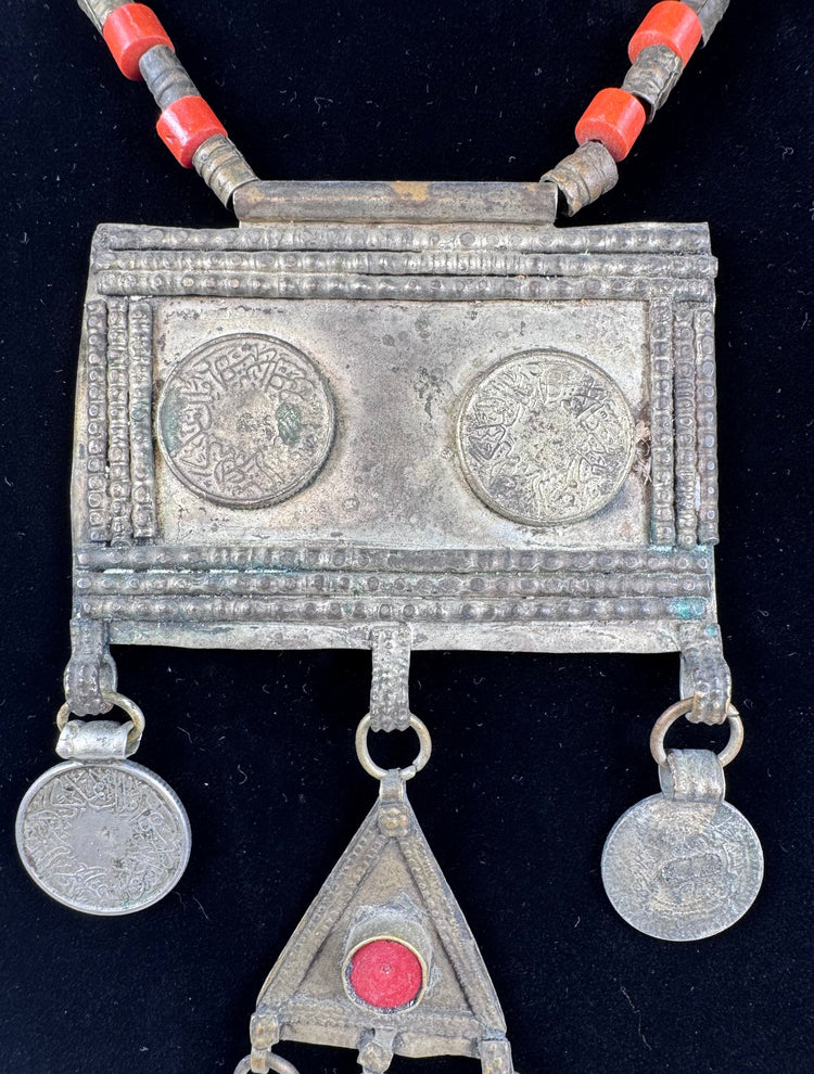 Late 19th-century Turkmen tribal necklace with Arabic coin motifs, red glass cabochon, and dangling chain ornaments.