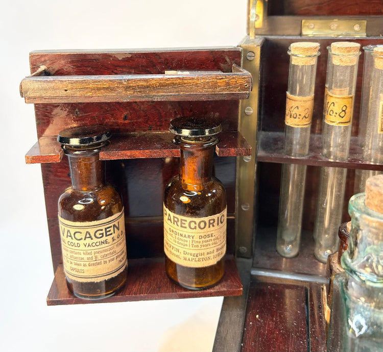 Close-up of Victorian apothecary bottles with paper labels and aged patina