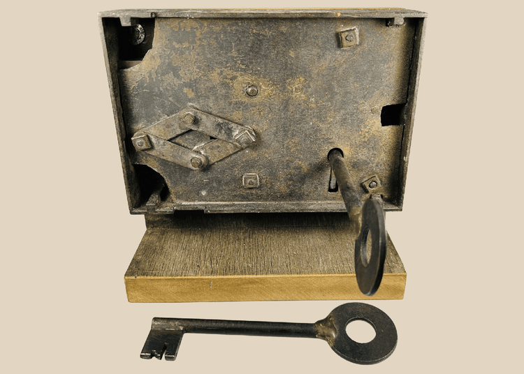 Antique 19th century iron rim lock with skeleton key on display