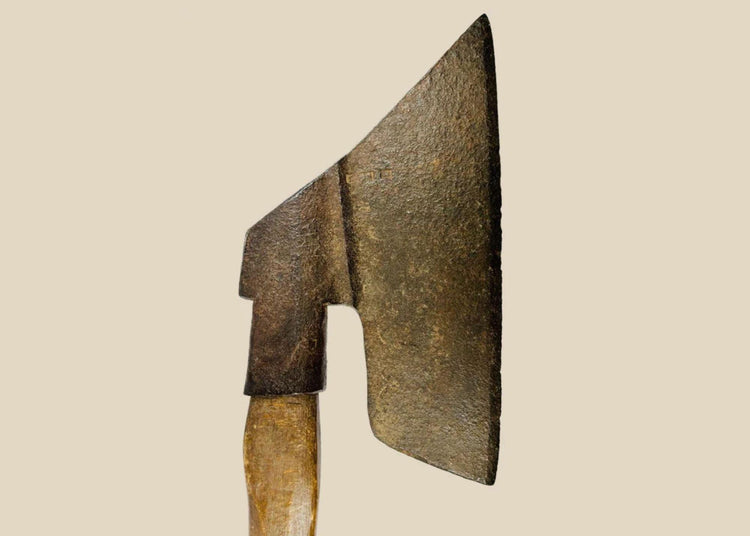 Antique European forged iron axe with wooden handle, featuring a leaf-shaped blade and tapered edge. Exhibits natural patina and surface wear consistent with 18th–19th century use, reflecting historical craftsmanship and utilitarian design.