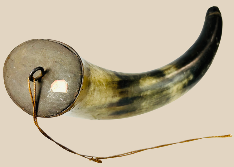 Antique powder horn displaying rich honey and olive-toned surface patina