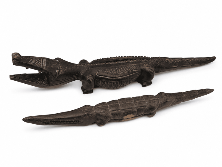 Malian hand-carved wood crocodiles with elongated bodies and dark aged surfaces