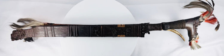 Early 20th-century Dayak sword with hand-forged blade and decorated scabbard