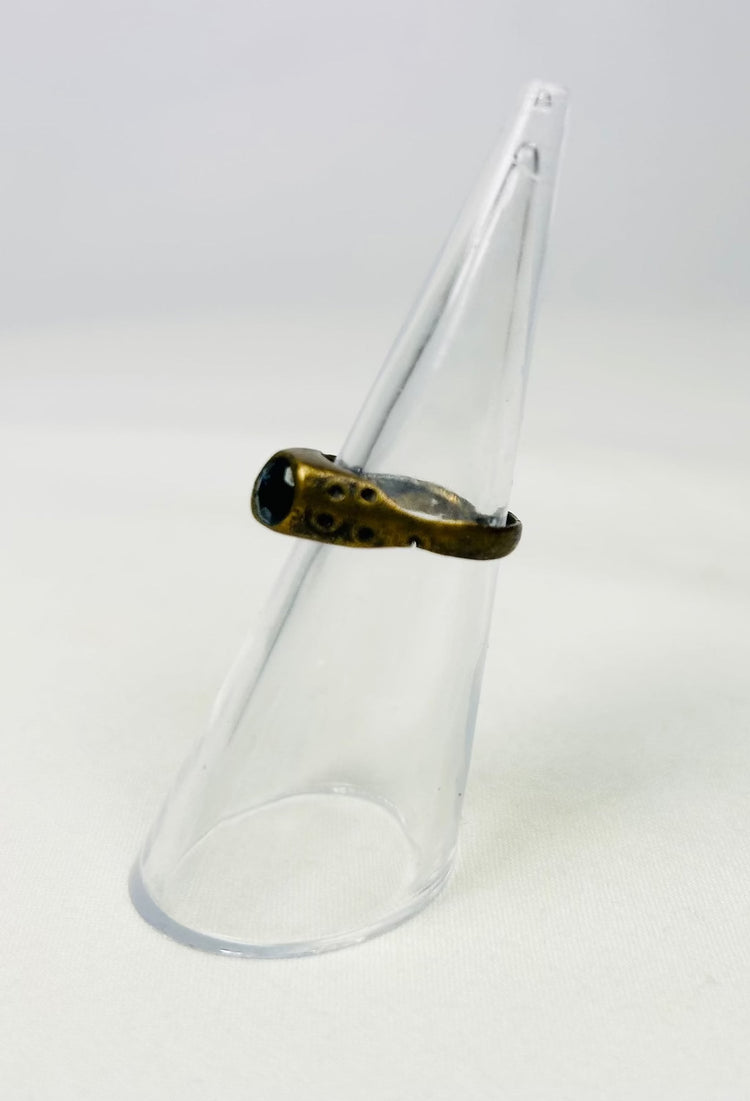 Late Roman brass ring displayed on a clear cone stand