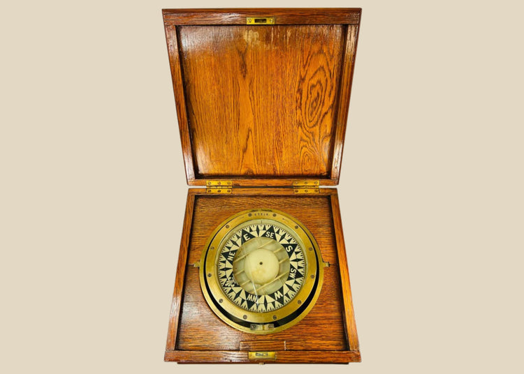 Antique brass ship compass by E.S. Ritchie, mounted in a fitted wooden case, originating from a Canadian political estate; nautical navigation instrument with original glass face, engraved directional markers, and aged patina, representing 19th–20th century maritime craftsmanship and provenance-linked historical significance.