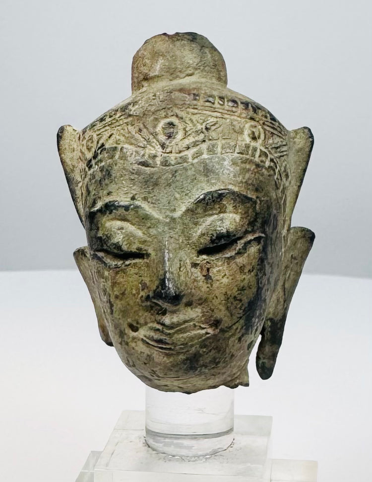 15th–18th century Southeast Asian bronze Buddha head with green-brown patina and traces of gilt