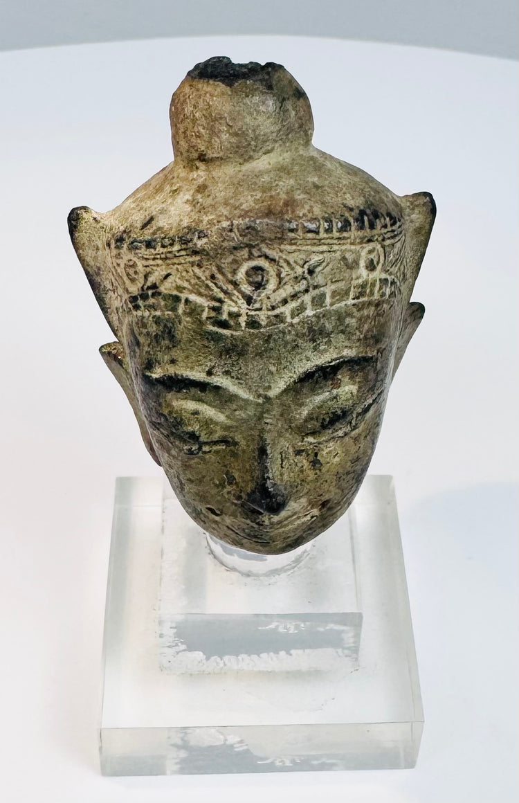 Historic crowned Buddha head with arched brows, closed eyes, subtle smile, and ornate crown band
