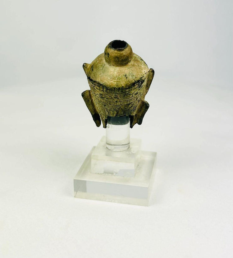 Rear view highlighting casting surface and patina on a bronze Buddha head