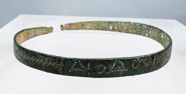 Ancient zoomorphic bronze bracelet with green, blue-green, brown, and earthen deposits