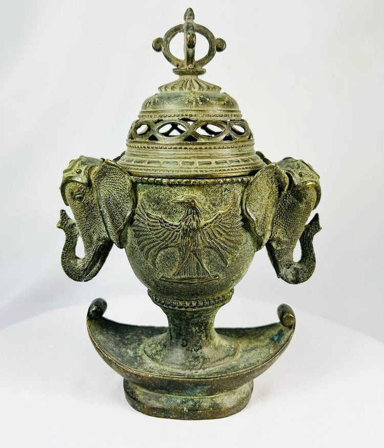 Antique Qing Dynasty bronze incense burner, circa 18th–19th century, with elephant-head handles, phoenix motifs, pierced domed lid crowned by a vajra finial, and crescent-shaped base, retaining traces of gilding and natural verdigris patina.