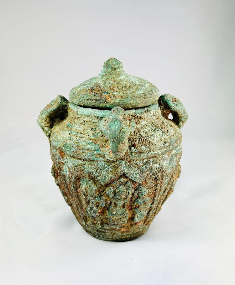 Early Chinese ritual bronze jar with lid and four decorative handles, intricate surface motifs, rich patina, Shang or Zhou dynasty, circa 1600–256 BCE, used for ceremonial or ancestral offerings.