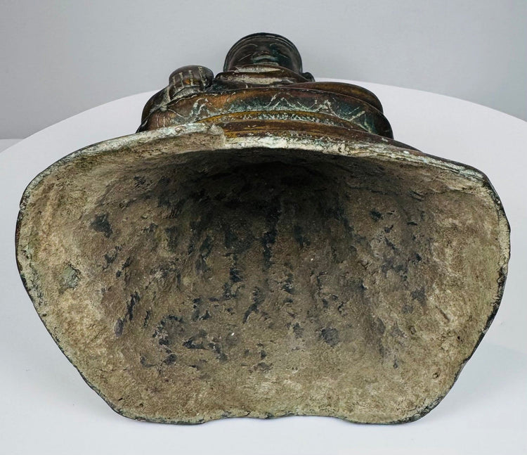 Open underside of the hollow-cast Burmese bronze Buddha with mineral deposits