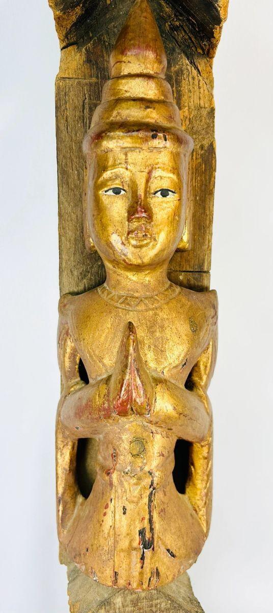 Monumental 45-inch Burmese temple finial, late 19th–early 20th century, carved hardwood with gilded Buddha in Anjali Mudra and spire form, retaining aged patina.
