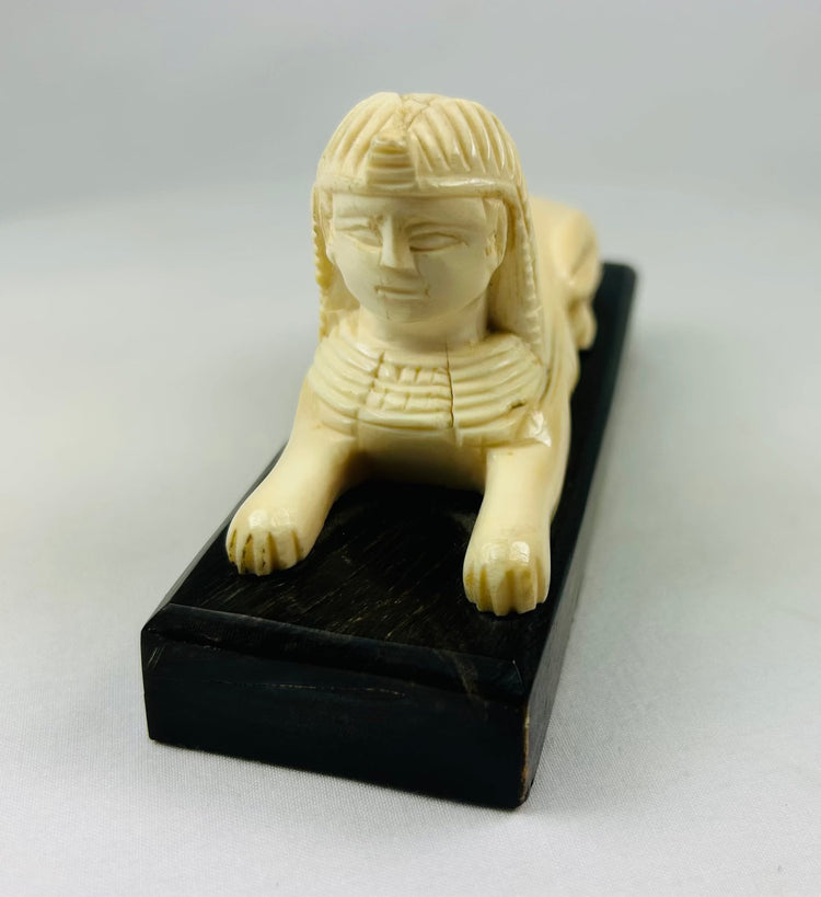 Egyptomania sphinx sculpture with pharaonic head and lion body, early to mid 20th century