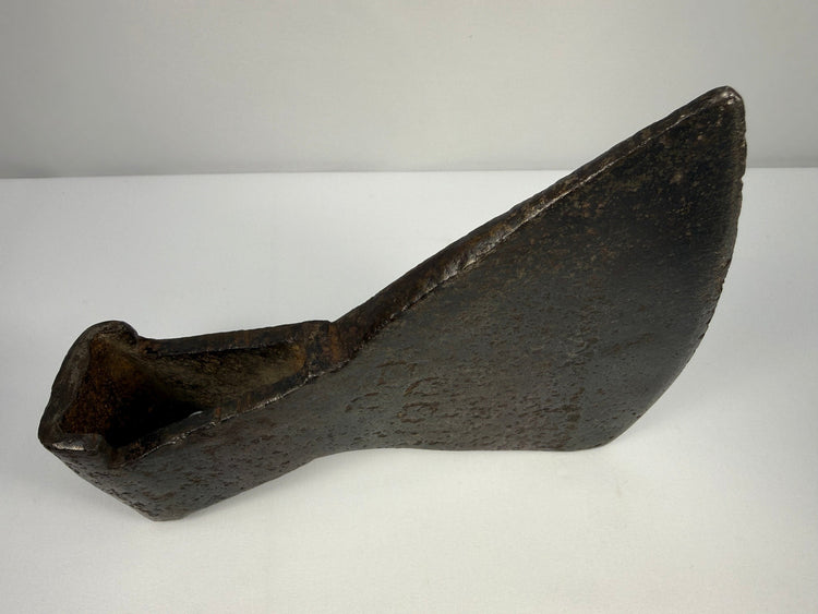 Colonial-era iron axe head with heavy wedge-shaped form and rich historic patina