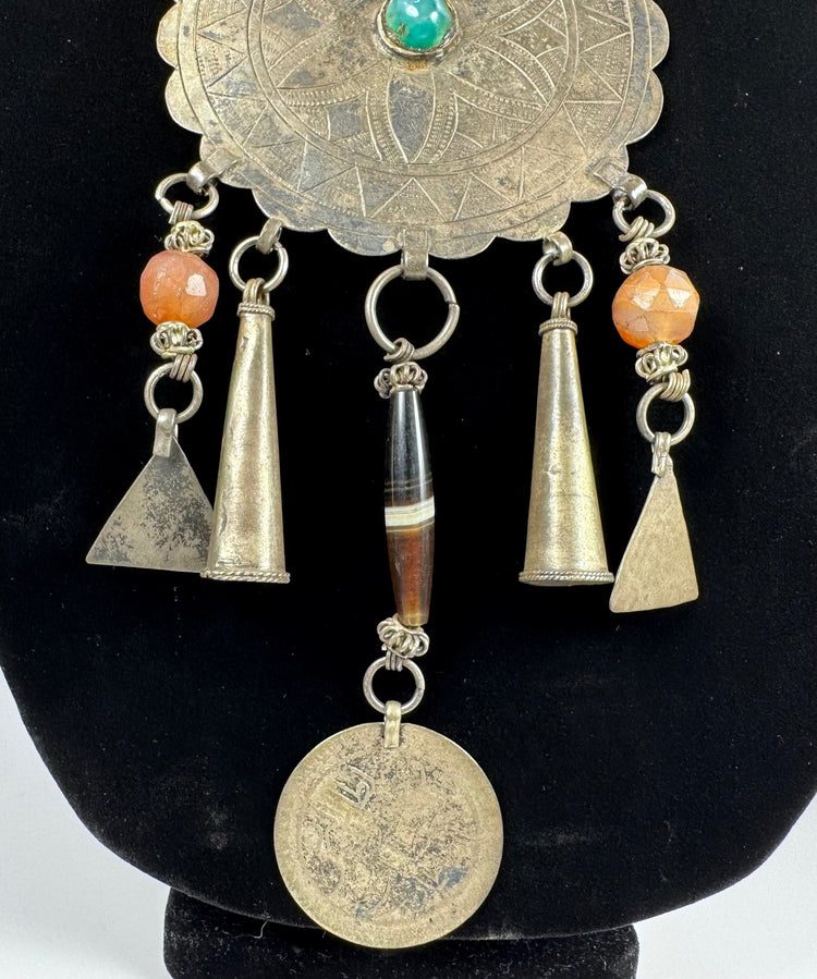 Traditional Afghan jewellery with rosette motif, coloured beads, and aged metal patina