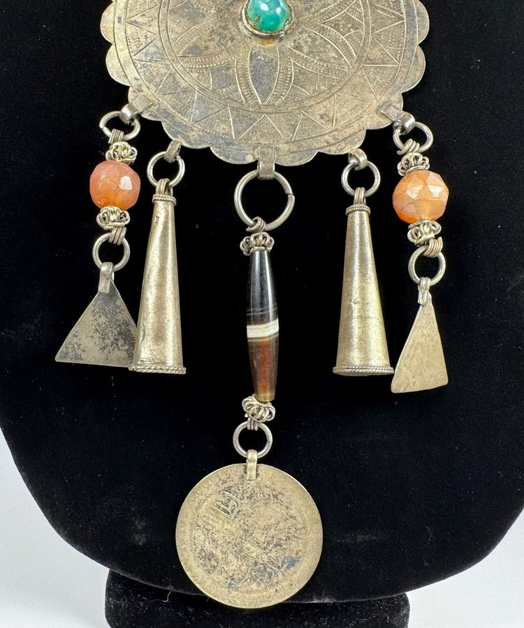 Traditional Afghan jewellery with rosette motif, coloured beads, and aged metal patina