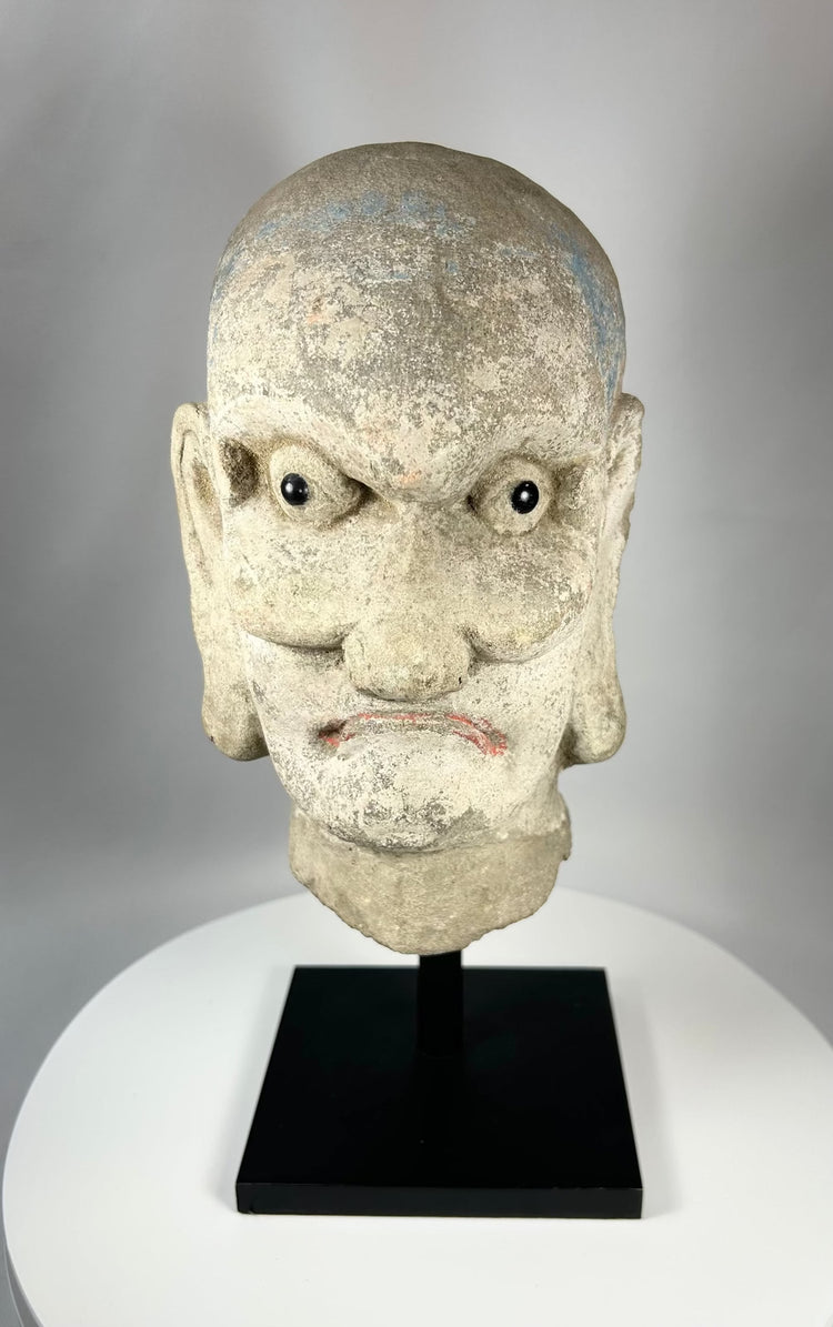 Antique Chinese Buddhist Luohan stone head sculpture with faint blue and red pigment, Qing Dynasty.