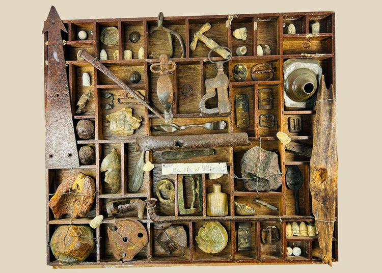 American Civil War shadow-box display of dug relics from the Battle of Vicksburg, Mississippi Valley, circa 1861–1865, featuring Minie balls, carved bullets, artillery and shell fragments, US plate and eagle breastplate pieces, spurs, stirrups, buckles, canteen spout, pipe bowl, glass bottle, camp hardware, all mounted in a wooden tray with wire supports and historic hand-written label