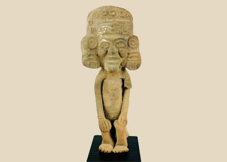 Mesoamerican Classic Period terracotta figure from Teotihuacan sphere with tall cylindrical headdress, incised roundels and step-fret band, large disk earspools, hands-on-knees posture, buff/orange clay with mineral accretions, mounted on modern black wood block, ca. 250–600 CE.