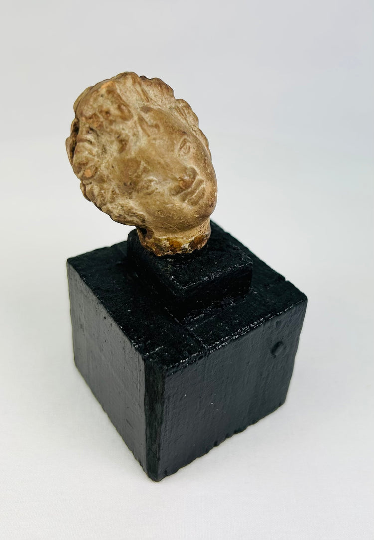 Ancient terracotta or stone head fragment, circa 1st millennium BCE–CE, likely Greek, Roman, or Near Eastern