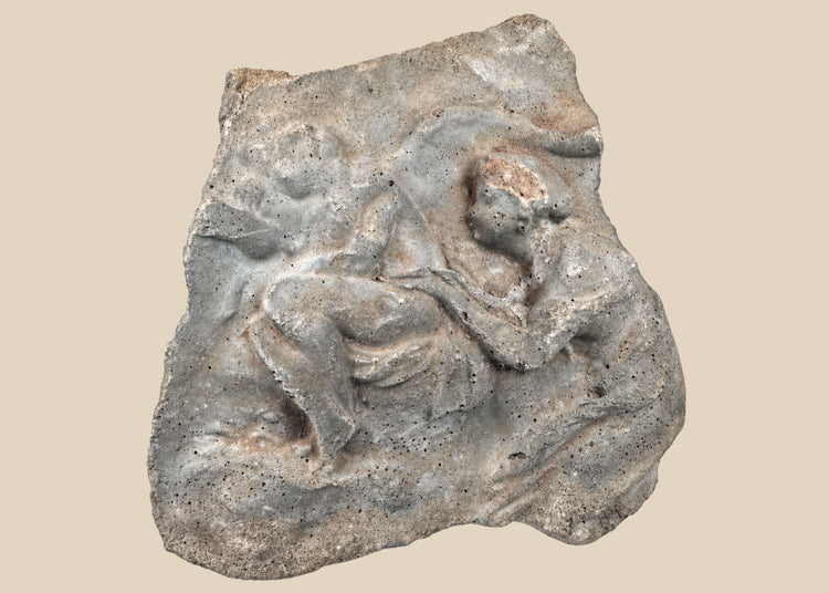 Ancient carved limestone relief fragment from the Mediterranean or Near East, Classical Period (circa 500 BCE–500 CE). Features two expressive human figures, likely part of a larger mythological or commemorative scene. Weathered surface and patina reflect centuries of age and Classical artistic traditions.