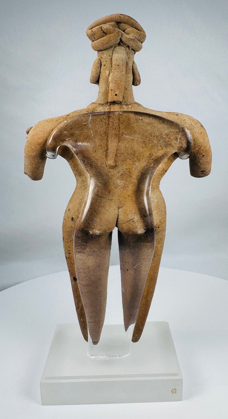 Ancient Colima ceramic female figure with stylized proportions, black painted body decoration, and mineral encrustation.