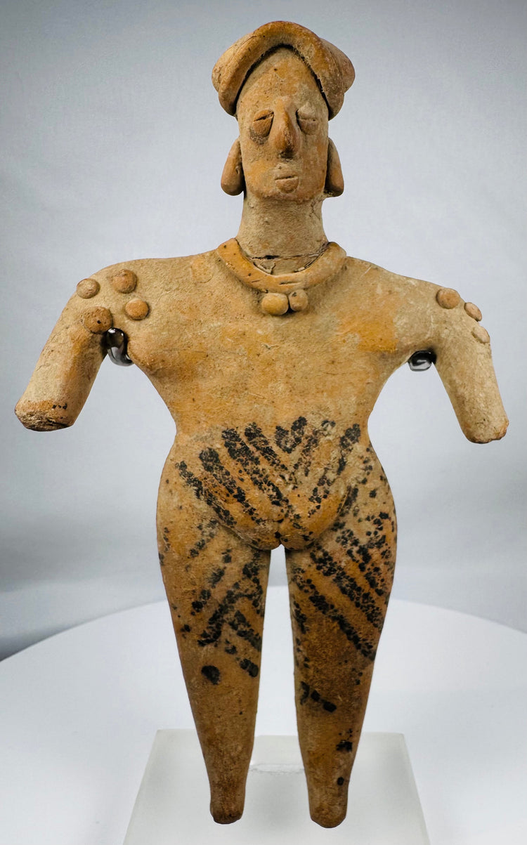 Pre-Columbian Colima female pottery figure featuring applied jewelry, black pigment motifs, and a custom display stand.