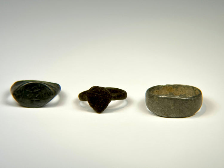 Ancient European bronze rings with oval signet bezel, shield-shaped bezel, and wide plain band