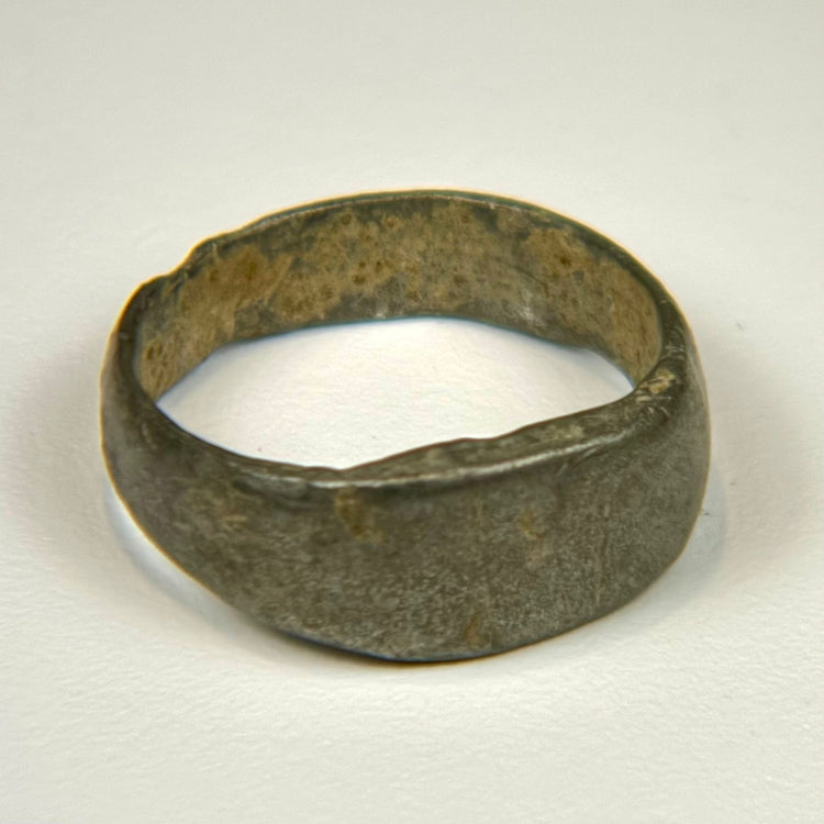 Heavy ancient bronze band ring with wide profile and mottled green-brown patina