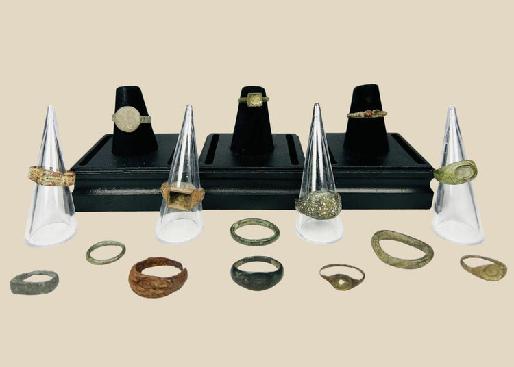 A curated collection of fifteen ancient bronze rings spanning Egypt, Rome, Byzantium, Viking, and Medieval Europe, featuring diverse patinas, signet bezels, wedding bands, and ceremonial designs, dating from 1000 BCE to the 15th century CE.